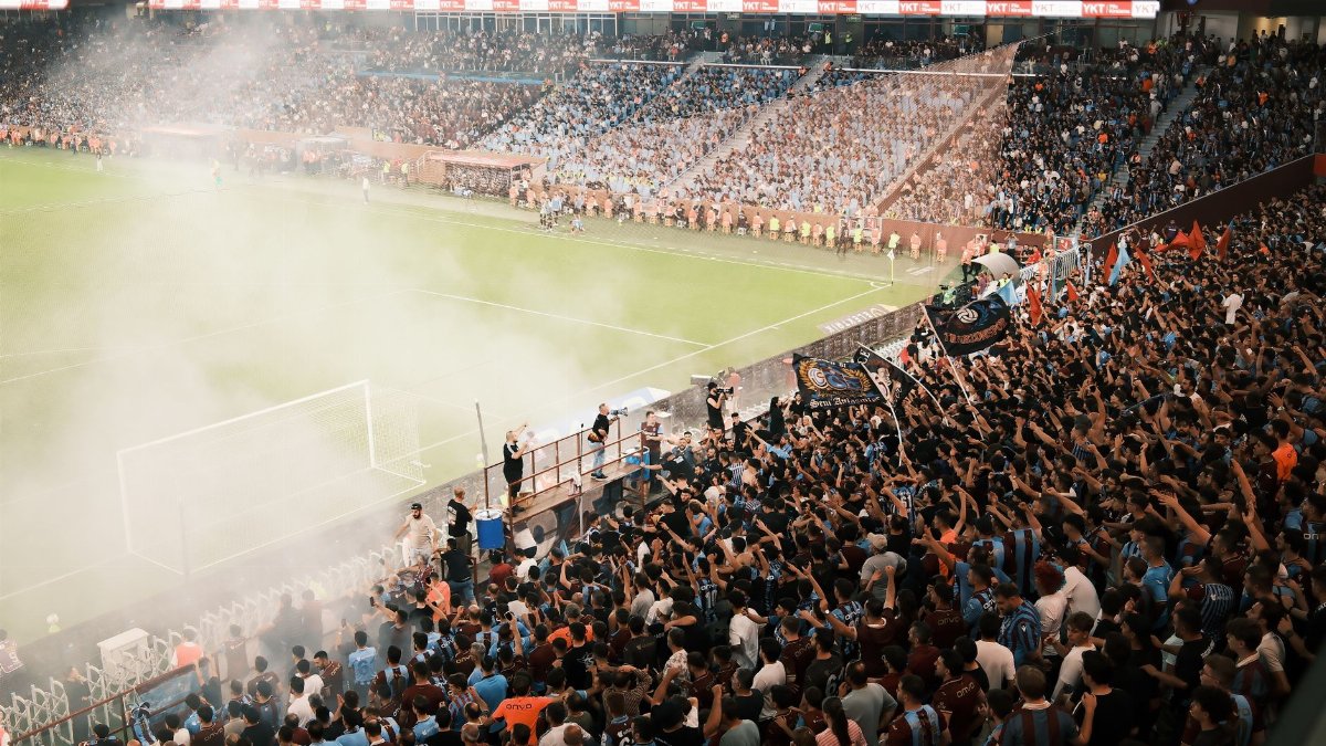 A vibrant scene of a packed soccer stadium with enthusiastic fans cheering during a match.