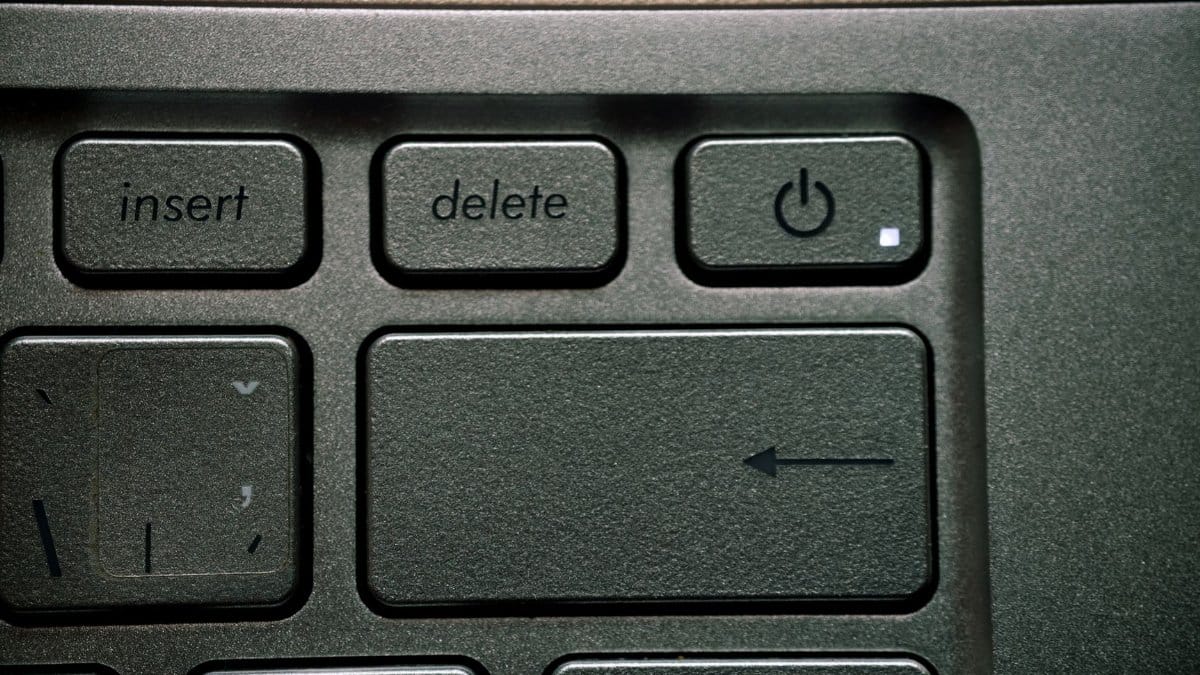 High-resolution close-up of an arrow key and functional keys on a computer keyboard.