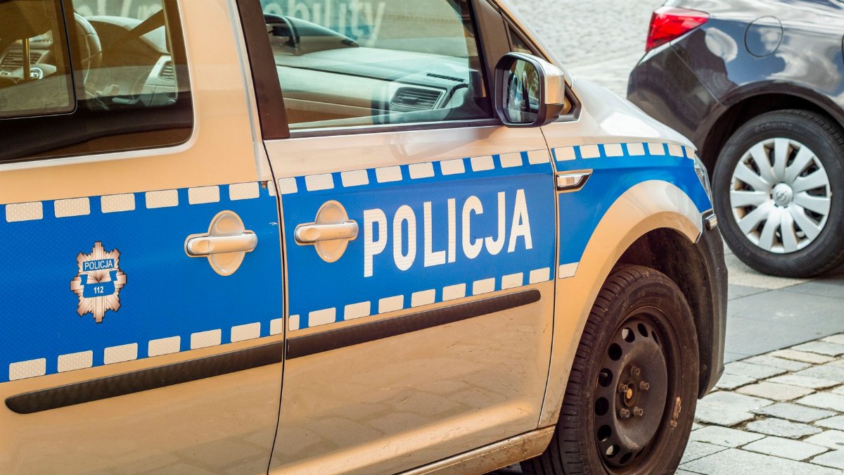 Detailed shot of a Polish police car parked on a cobblestone street.