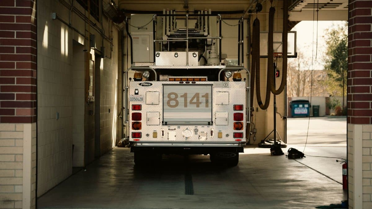 A fire truck parked inside a station's garage, showcasing emergency preparedness.