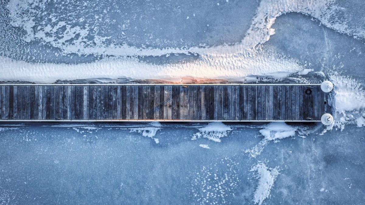 Overhead shot of a frozen wooden pier in Lake City, Minnesota during winter.