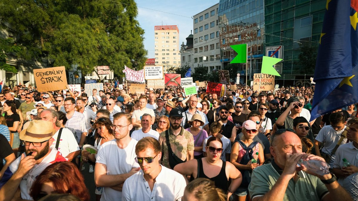 A diverse crowd peacefully protesting in Bratislava, Slovakia, showcasing cultural unity and civic engagement.