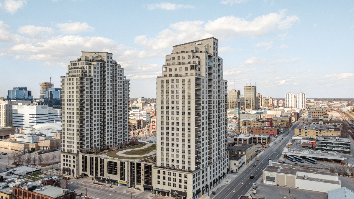 High-rise buildings in downtown London, Ontario under a clear sky.