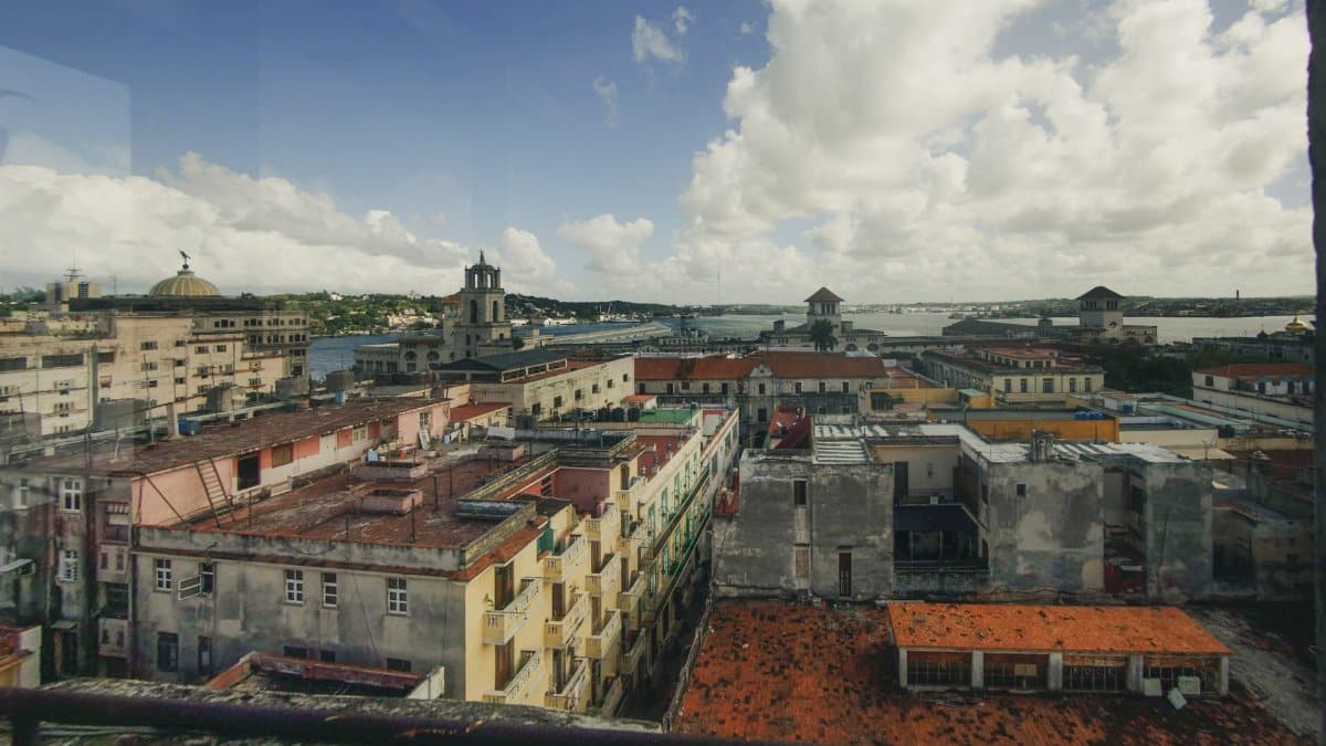 Stunning cityscape view with colorful architecture and scenic waterfront under a cloudy sky.