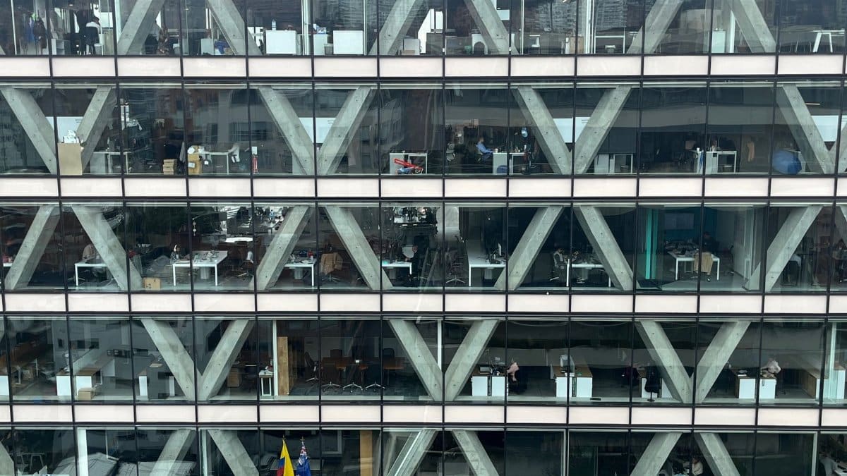 Office building facade with glass windows and geometric patterns in Bogota, Colombia.