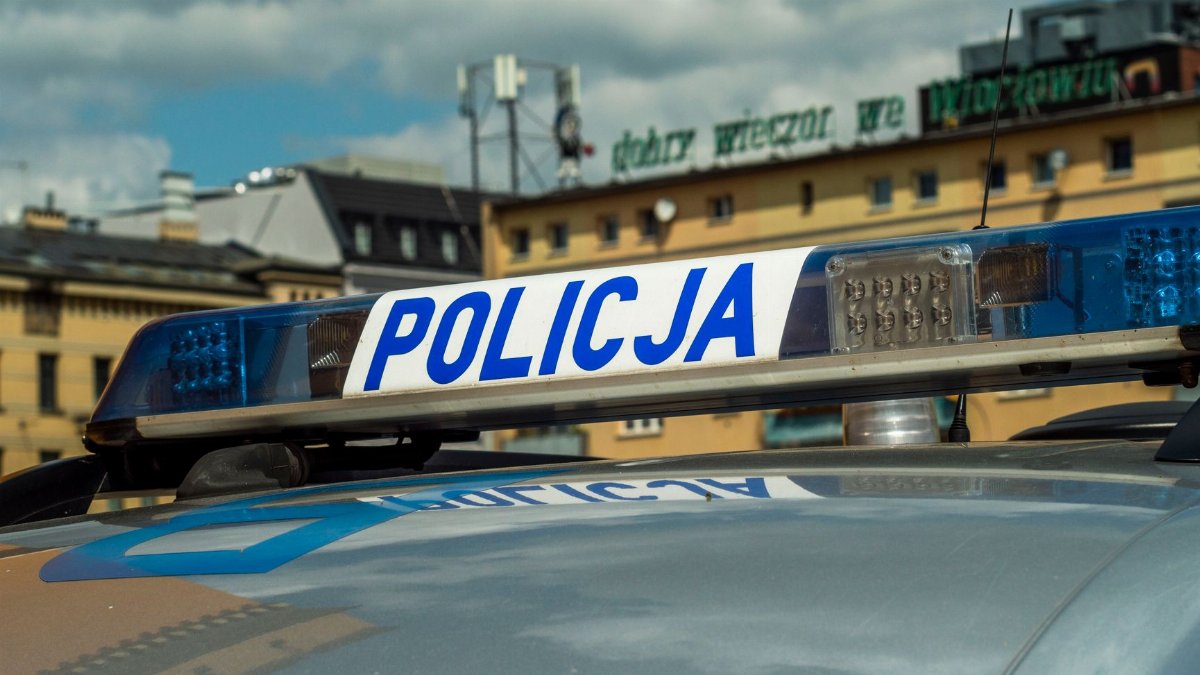 Close-up of Polish police car light bar with buildings in the background.