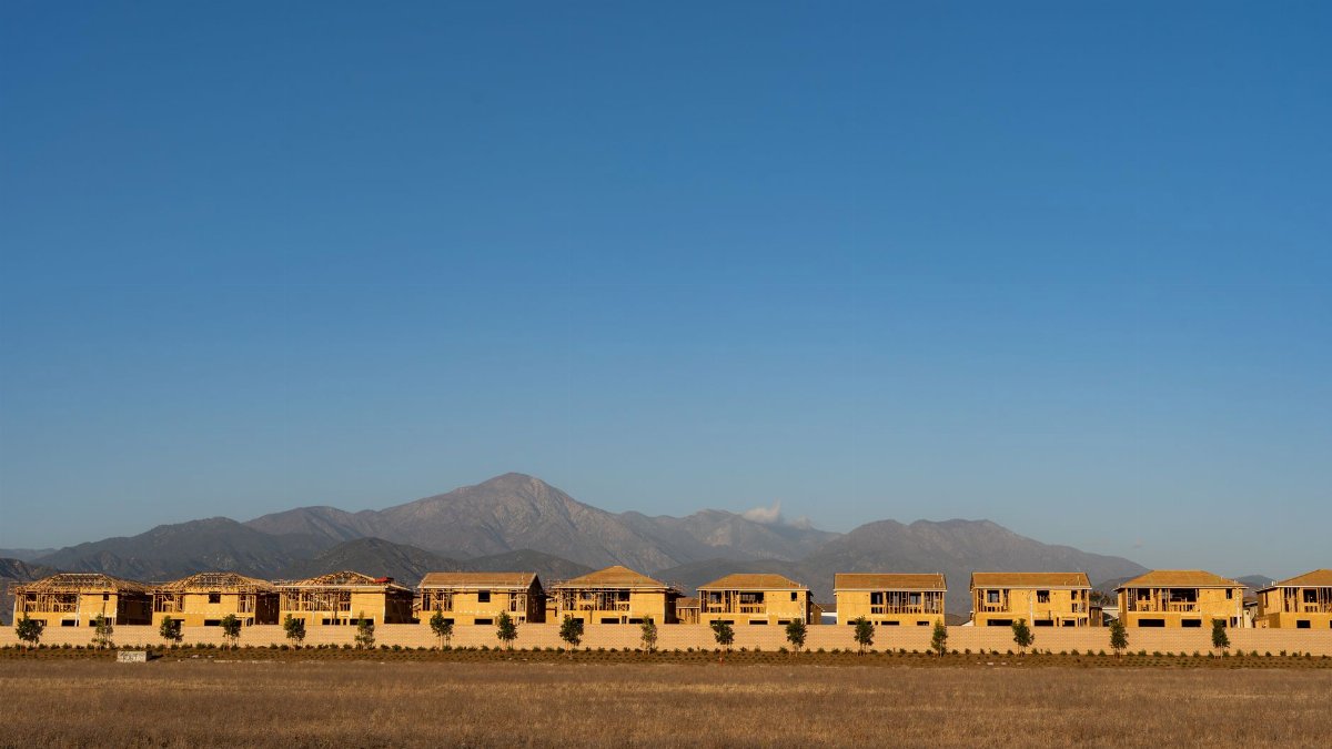 A row of unfinished houses with mountains in the background, Redlands, CA.