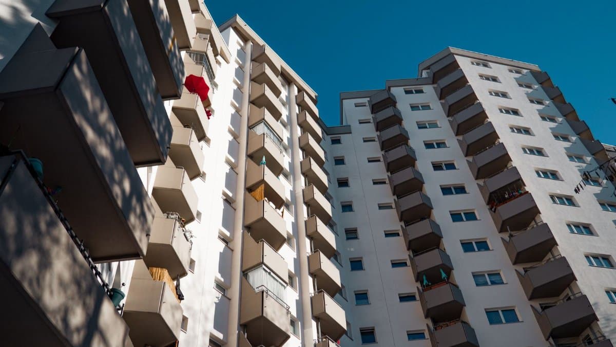 Low-angle view of modern residential apartment buildings in Berlin under clear sky.