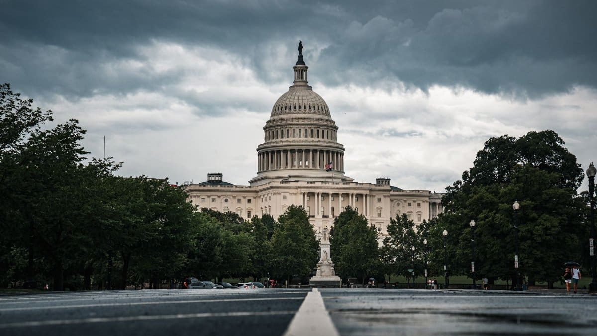 Dramatic view of the US Capitol under cloudy skies, showcasing Washington DC's historic architecture.