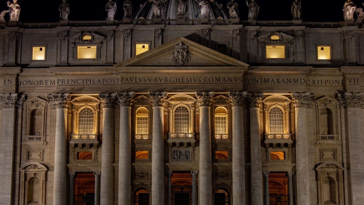 Illuminated St. Peter's Basilica at night, showcasing exquisite architectural details in Vatican City.