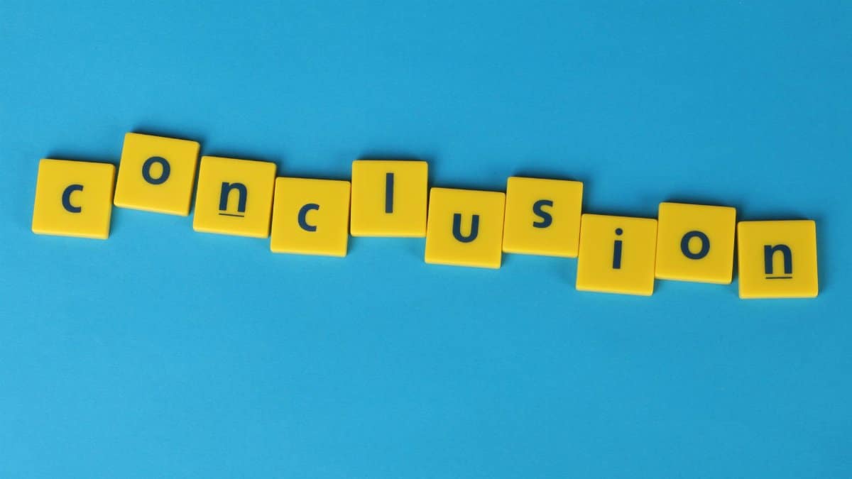 Yellow letter tiles spelling 'conclusion' on a vibrant blue background emphasizing creativity and achievement.