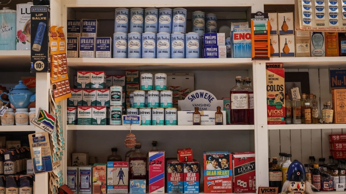 A vintage shop shelf featuring retro packaging of various products and medicinal items.
