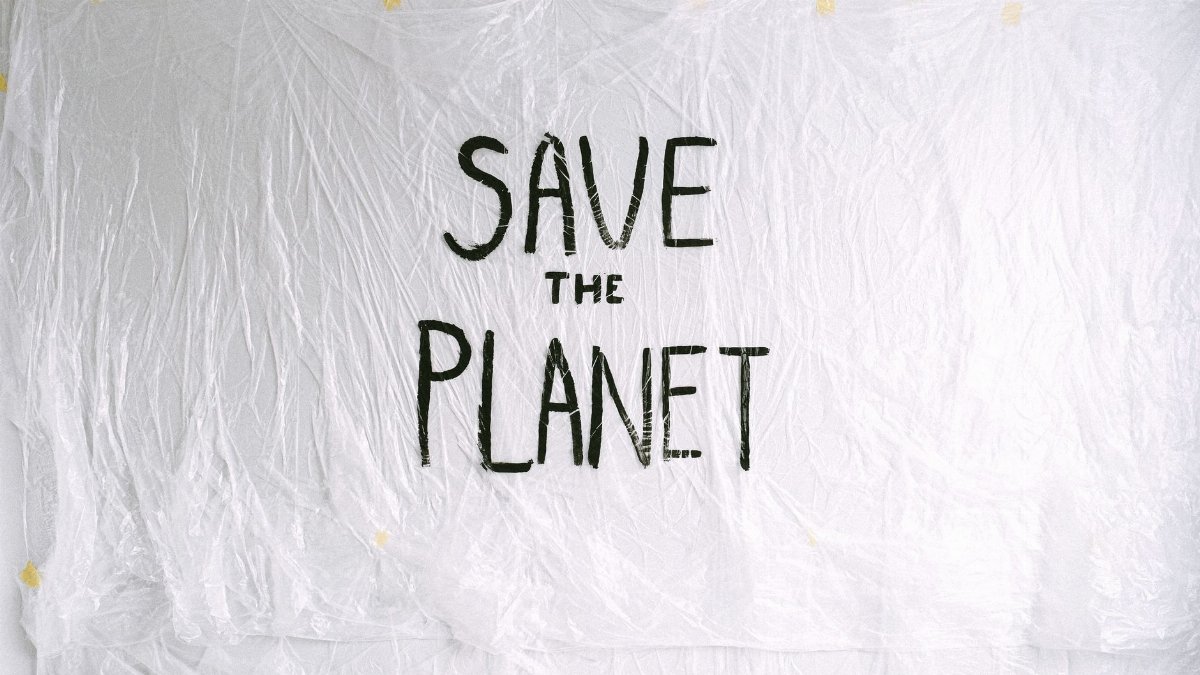 Eco-friendly message on white plastic background promoting environmental conservation.