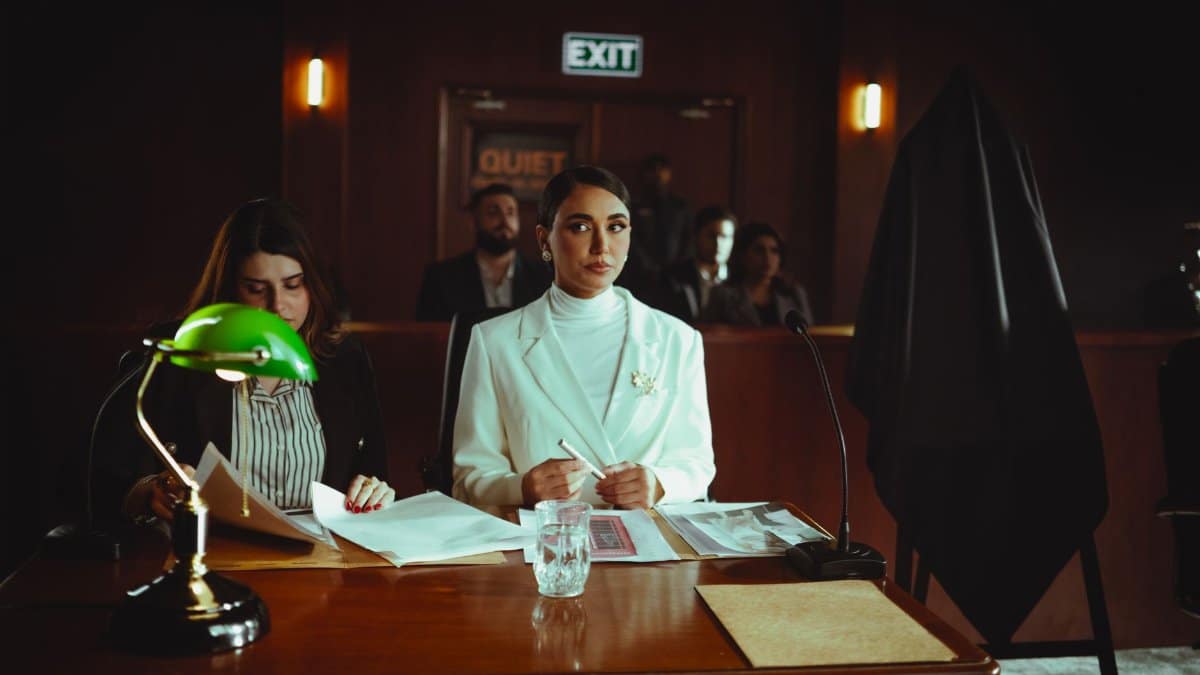 A courtroom scene in Baghdad with lawyers and participants engaged in legal proceedings.