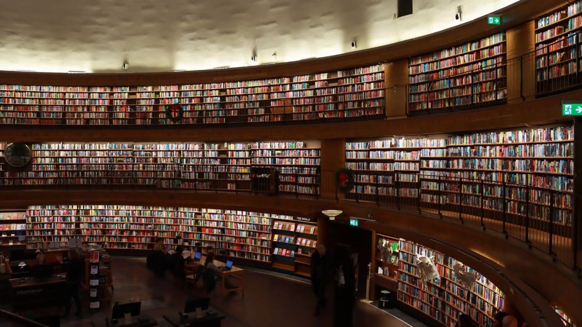 A vast collection of books lining the shelves of Stockholm's iconic public library.
