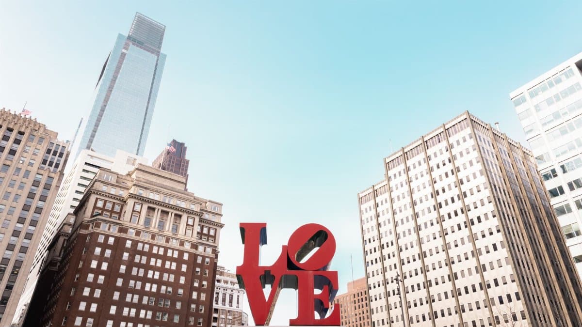 The iconic LOVE sculpture against Philadelphia's downtown skyline on a clear day.