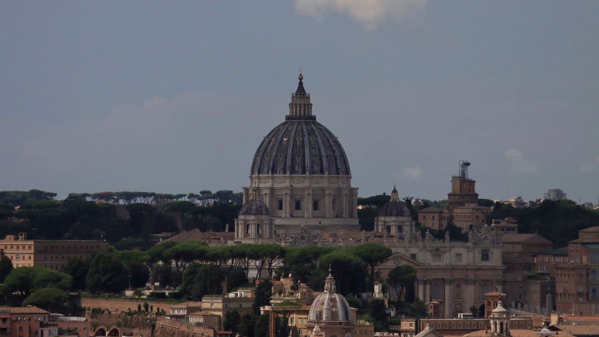 A stunning view of St. Peter's Basilica dominating the Rome skyline, highlighting its iconic dome.