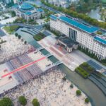 Aerial view capturing a busy city square filled with people and surrounded by buildings in China.