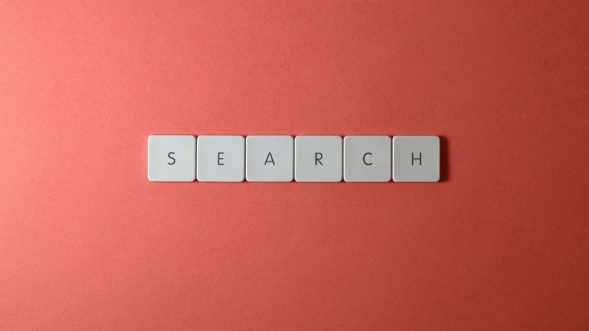 White keyboard keys spelling 'search' on a bold red surface, conceptual design with copyspace.