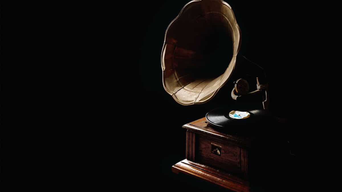 A classic gramophone with vinyl record, showcasing vintage charm in a dark ambiance.