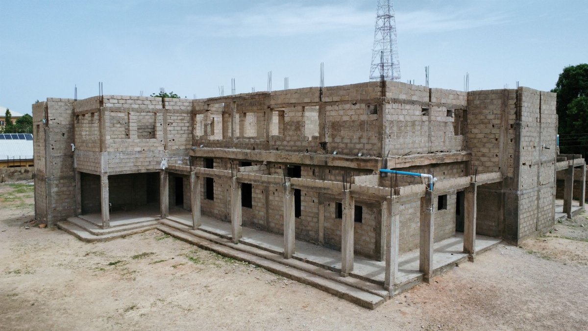 An unfinished concrete building in outdoor setting with clear sky