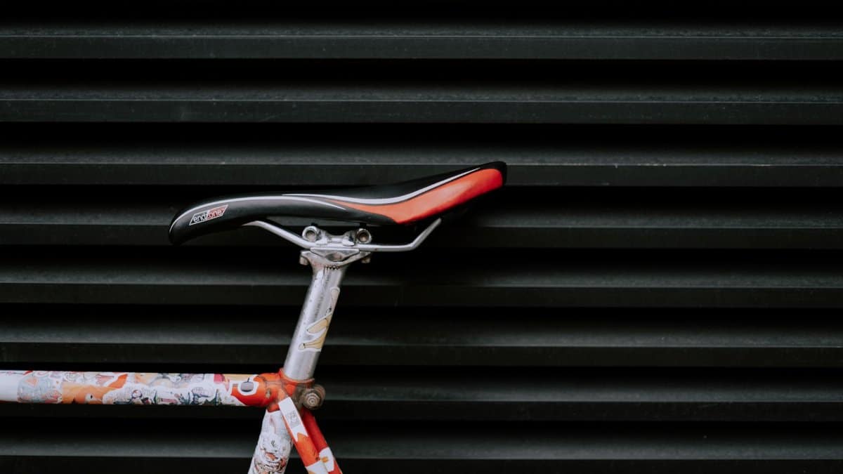 Close-up of a modern bicycle seat against a geometric patterned wall.