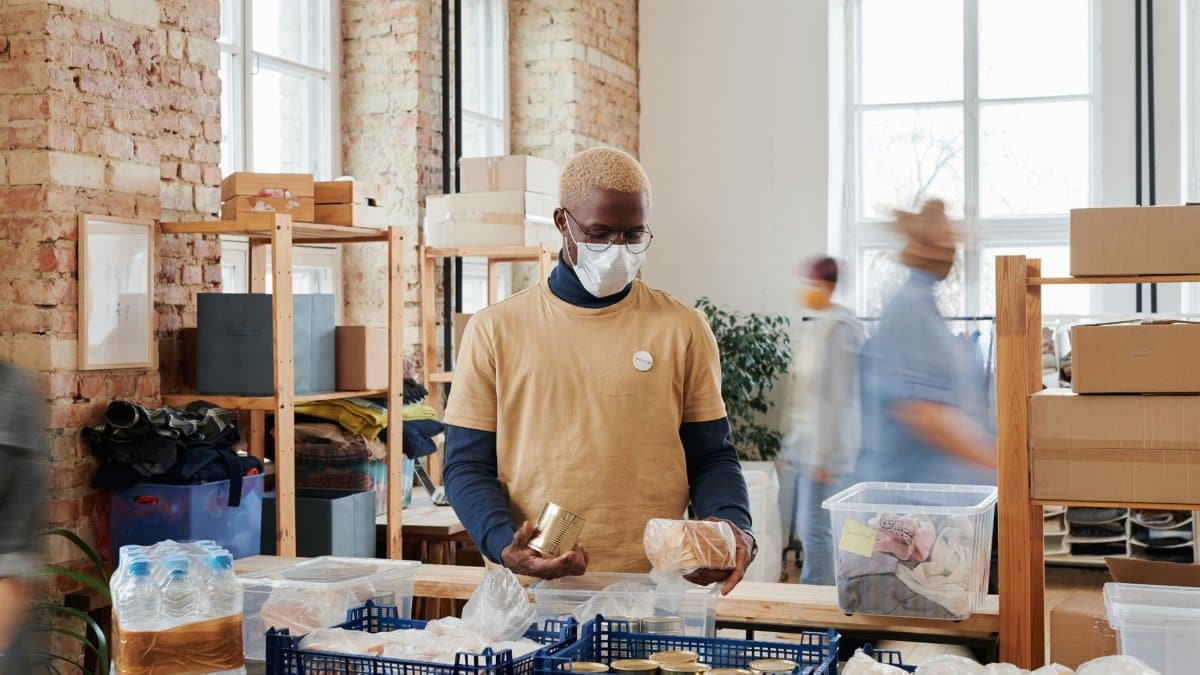 Volunteers sort and organize food donations in a community center to help those in need.