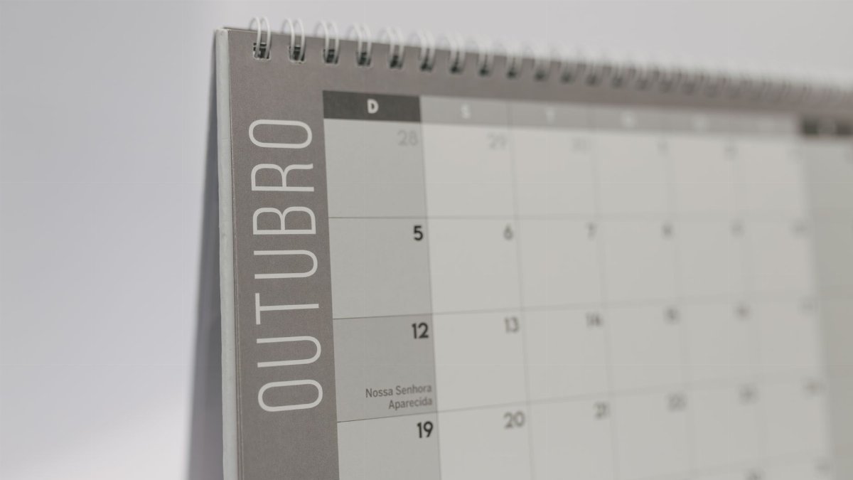 Close-up of October's page on a standing desk calendar with smooth minimalist design.