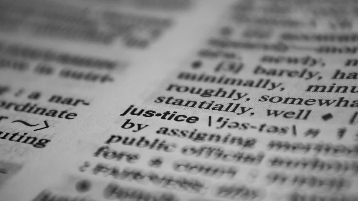 Selective focus close-up of the word justice in a dictionary, emphasizing concept clarity.