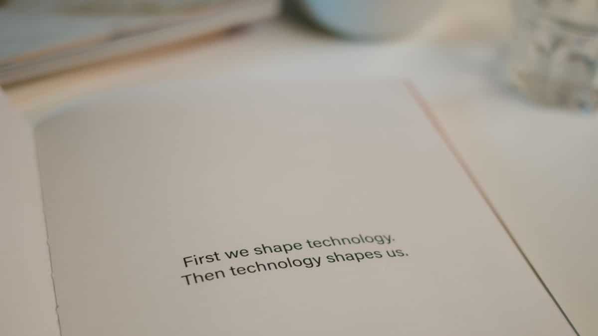 Open book with quote on technology's influence, perfect for tech inspiration.