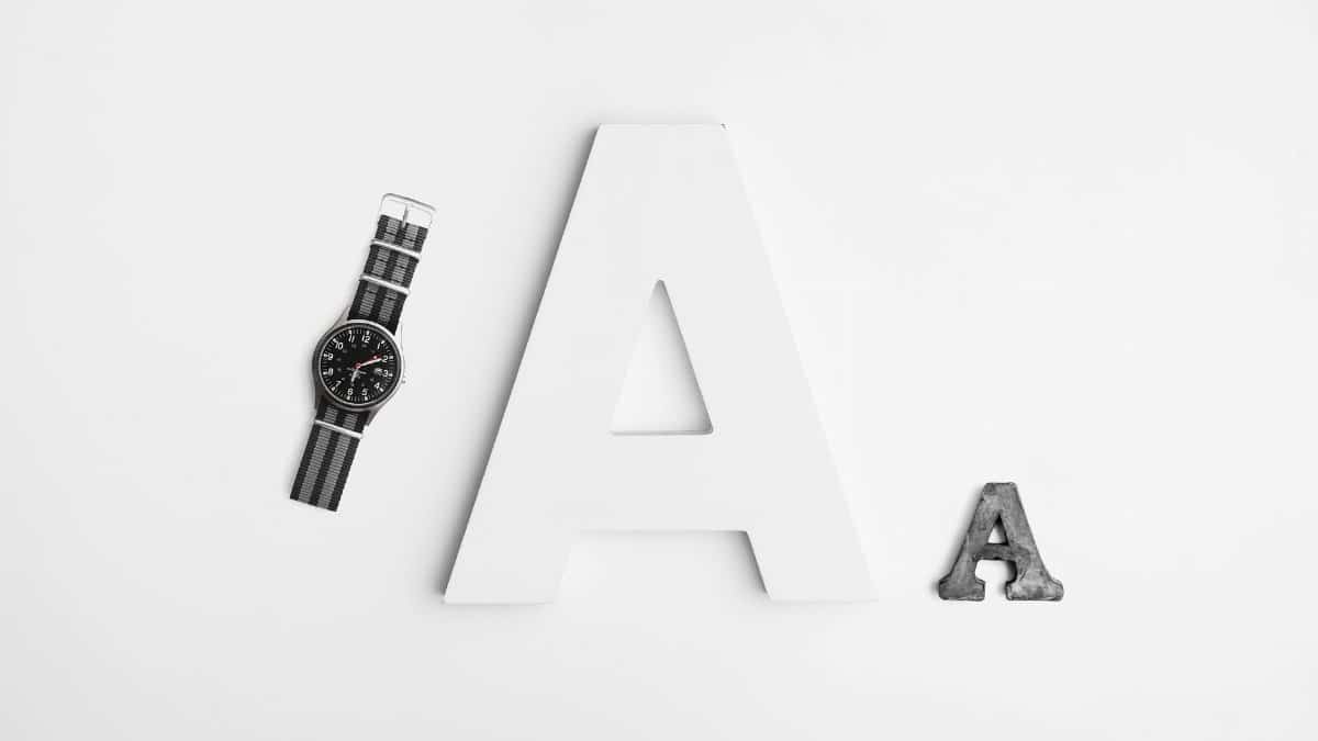 Minimalist layout featuring typography with a sleek watch and bold letter A design.