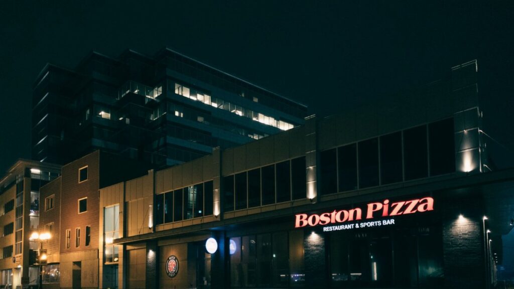Illuminated Boston Pizza restaurant facade at night in St. John's, Newfoundland, Canada.