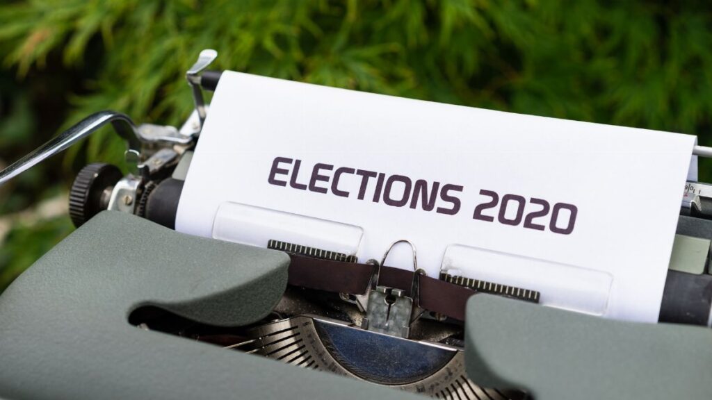 Close-up of a typewriter typing 'Elections 2020' outdoors.