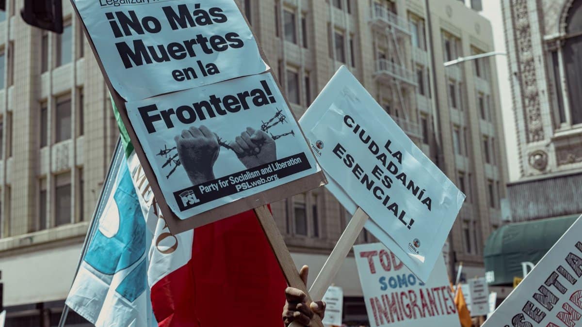 Protesters in Los Angeles rally for immigration rights with powerful messages on signs.