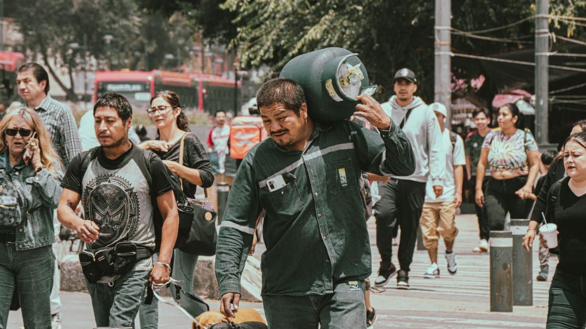 People walking on a bustling city street, engaged in various activities.