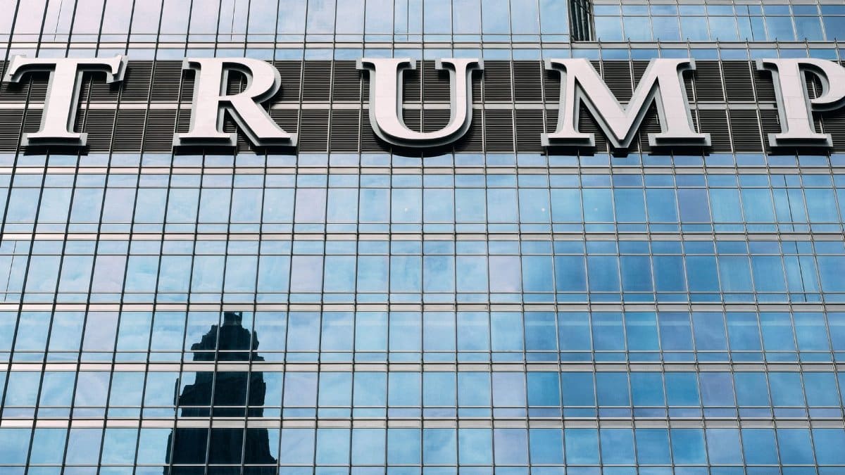 Close-up of Trump Tower's glass facade with the city skyline reflection in the windows.