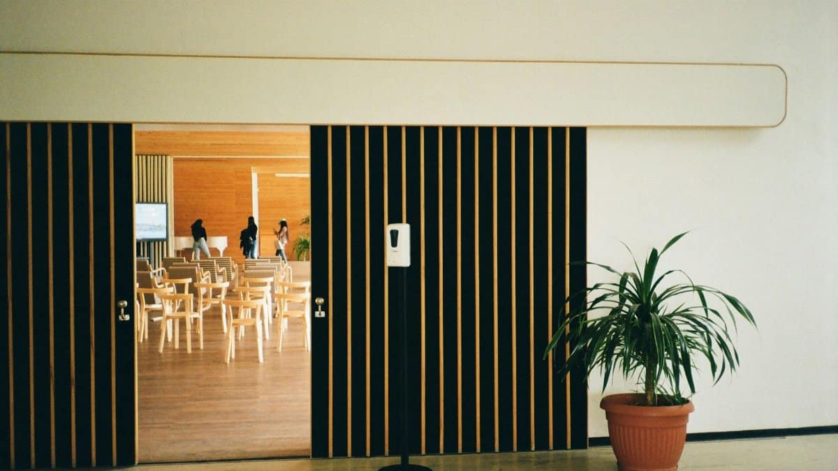 Open doors reveal a modern hall with chairs and plants in Vyborg, Russia.