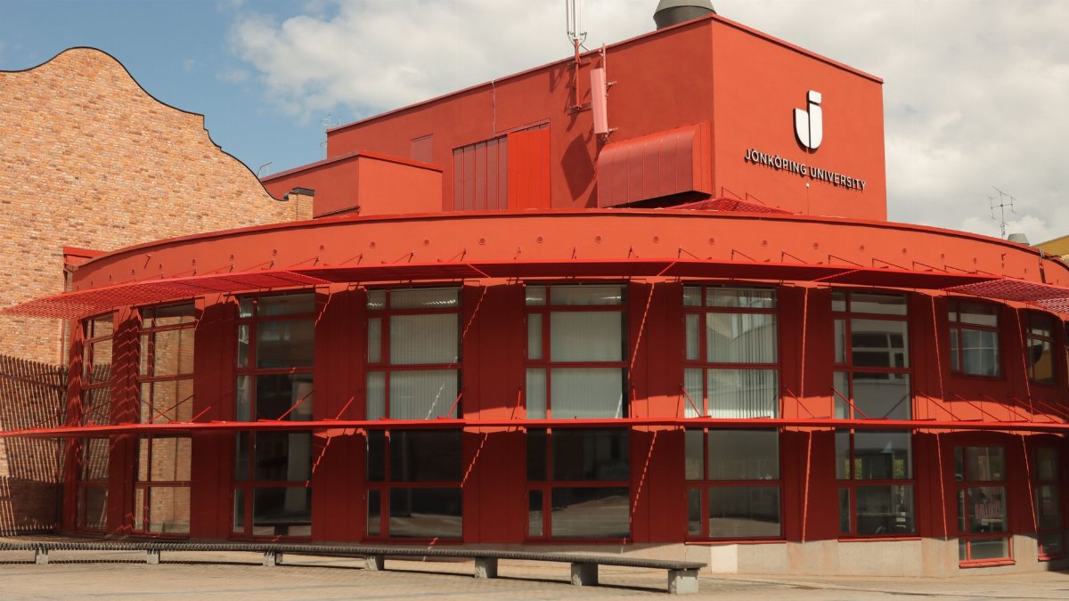 Explore the striking modern design of Jönköping University in Sweden with its vibrant red facade.