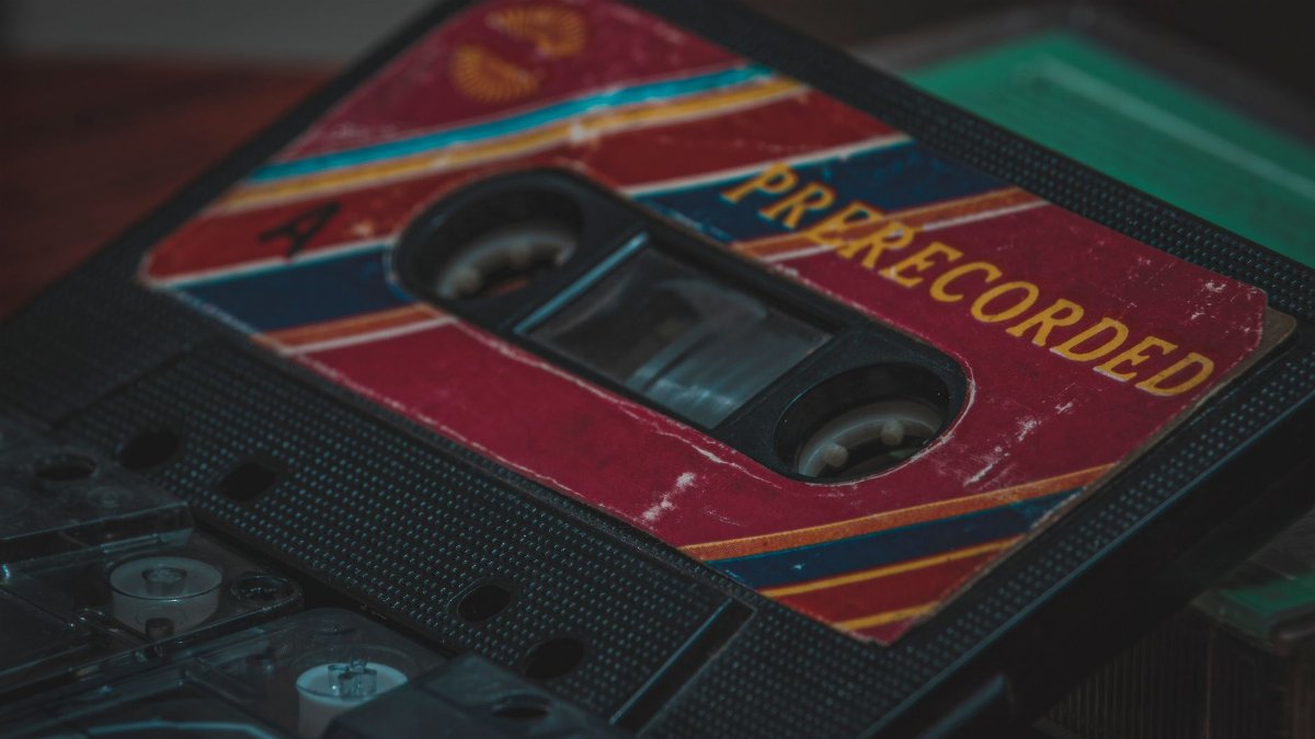 A detailed shot of a vintage prerecorded cassette tape with a retro design, capturing nostalgia.