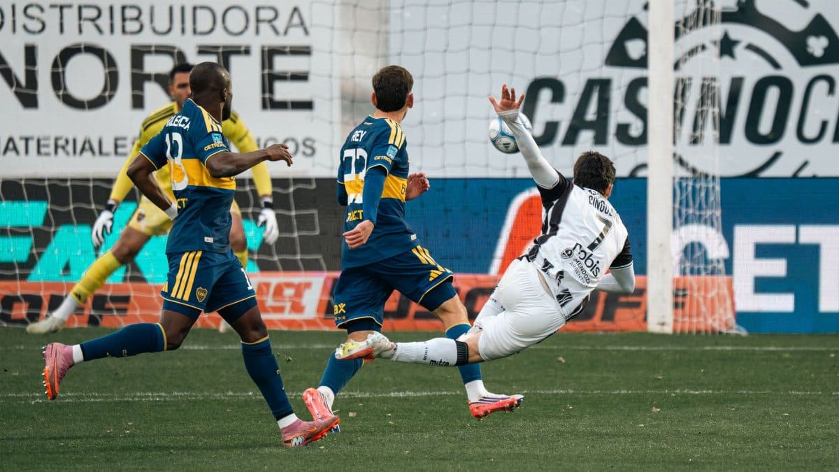 Dramatic moment as a player attempts to score a goal in a competitive soccer match.