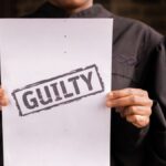 A judge in a courtroom holding a paper with a guilty verdict, symbolizing law and justice.