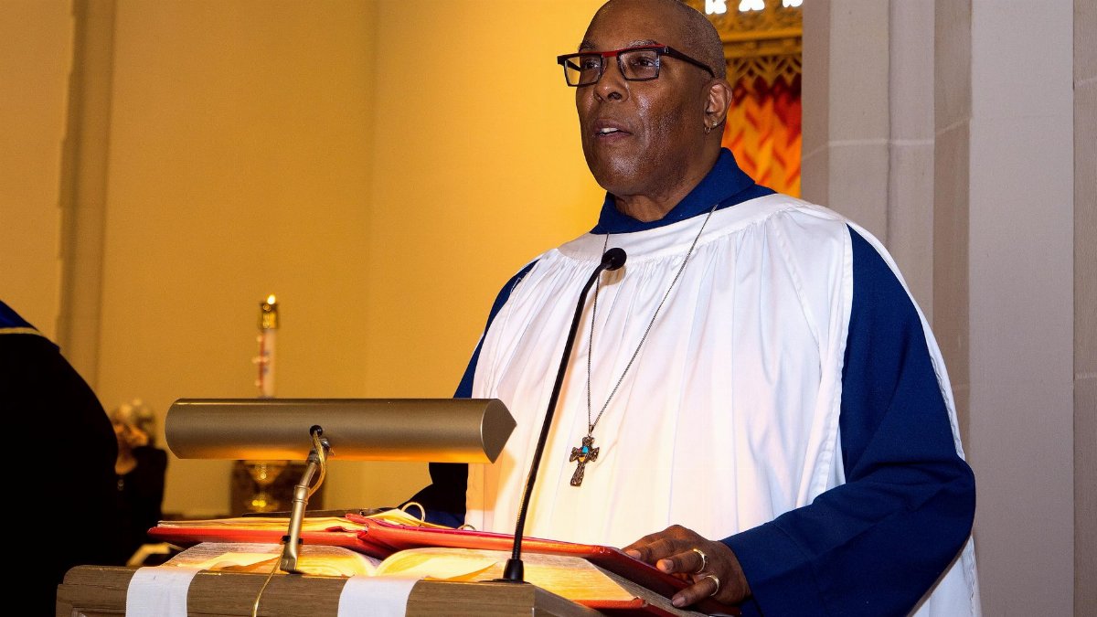 Pastor delivering a sermon in a church, emphasizing religious practice and spirituality.