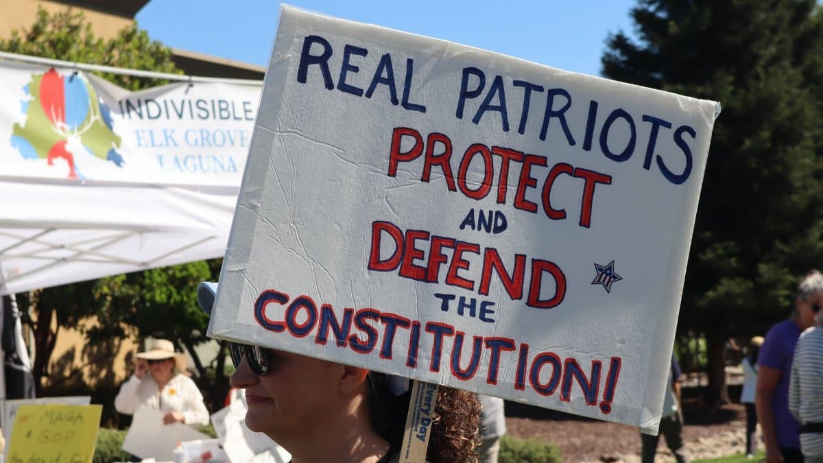 Protesters in Elk Grove advocate for constitutional protection with bold signs.