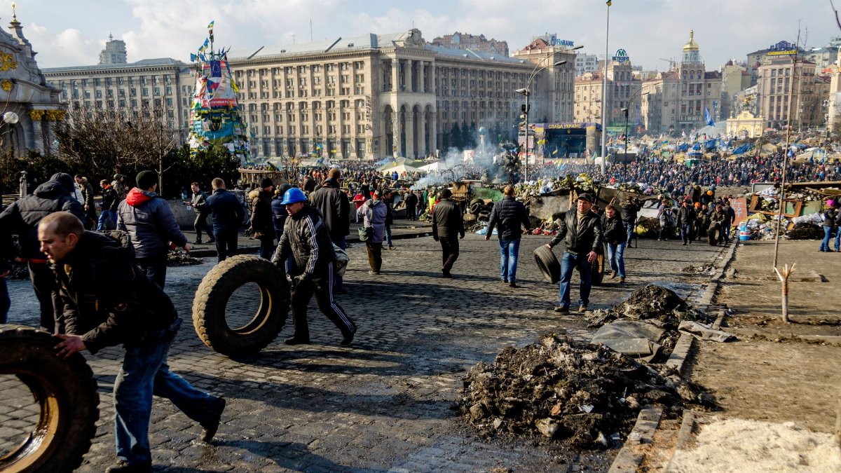 Crowded protest at Independence Square, Kyiv, Ukraine during daytime.