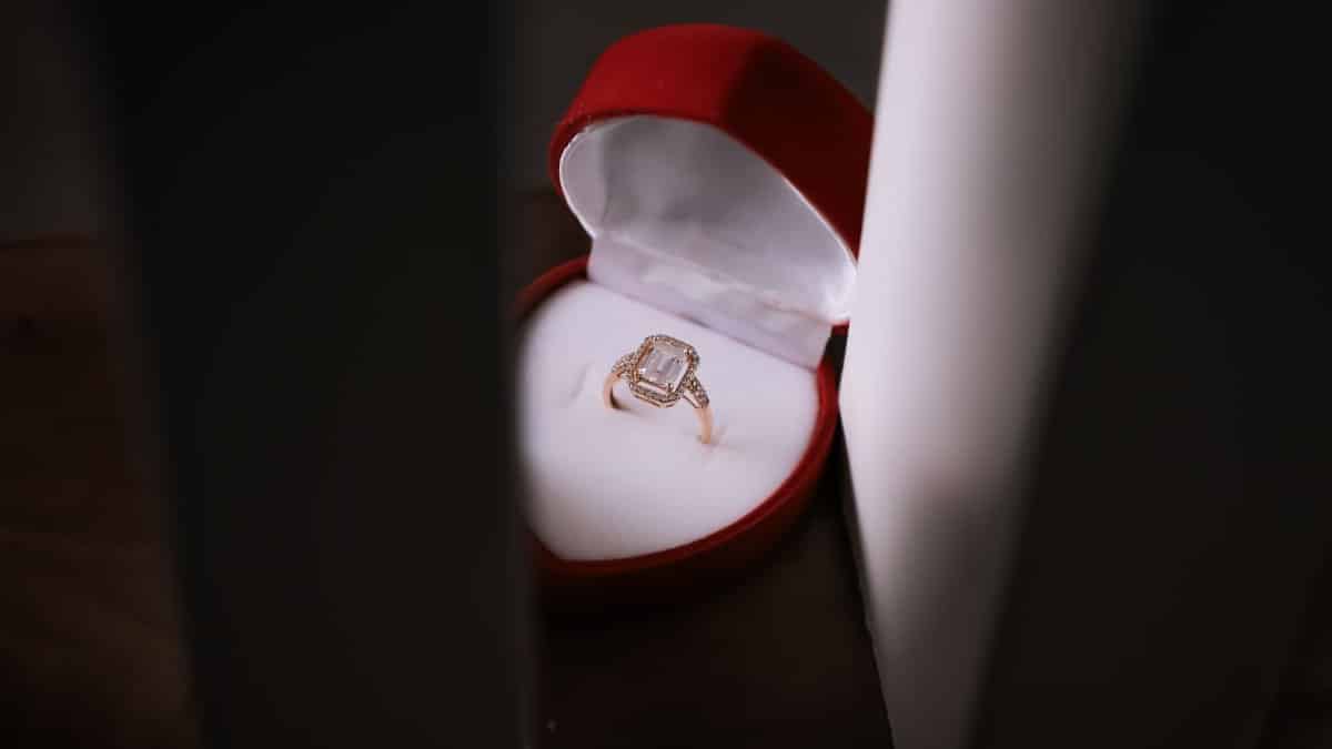 Close-up of a stunning diamond ring in a red velvet box, capturing elegance and romance.