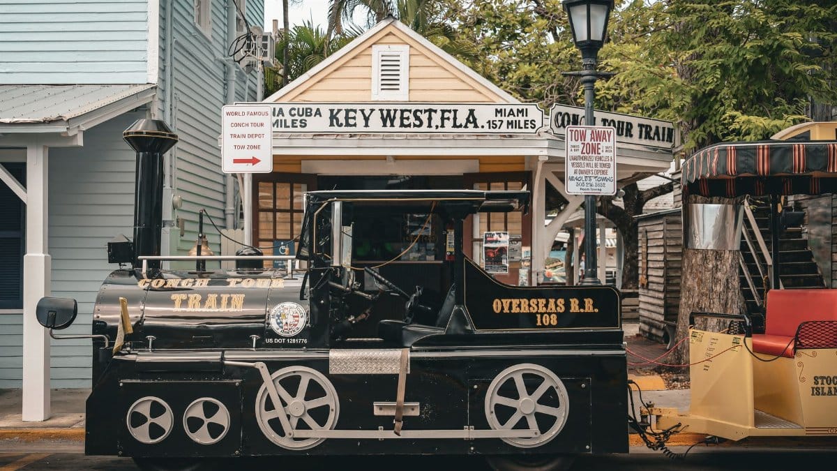 Scenic view of Conch Tour Train parked in Key West, Florida, capturing a vintage travel charm.