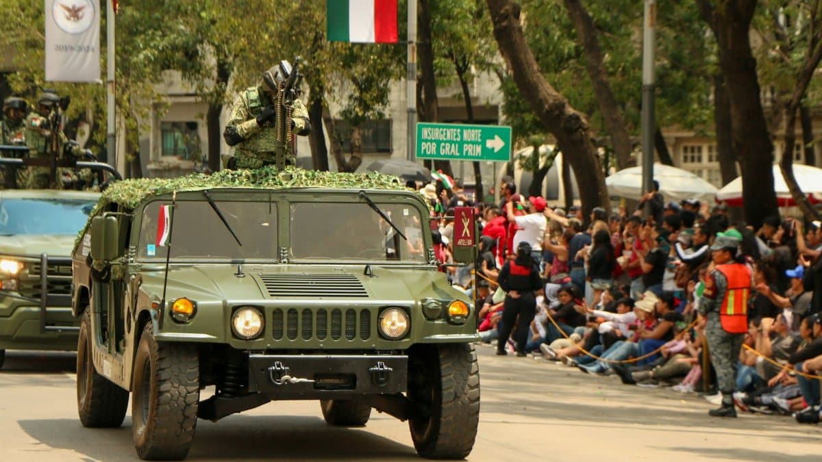 Military vehicles on parade in Mexico City, showcasing strength and unity. Captured during a significant event.