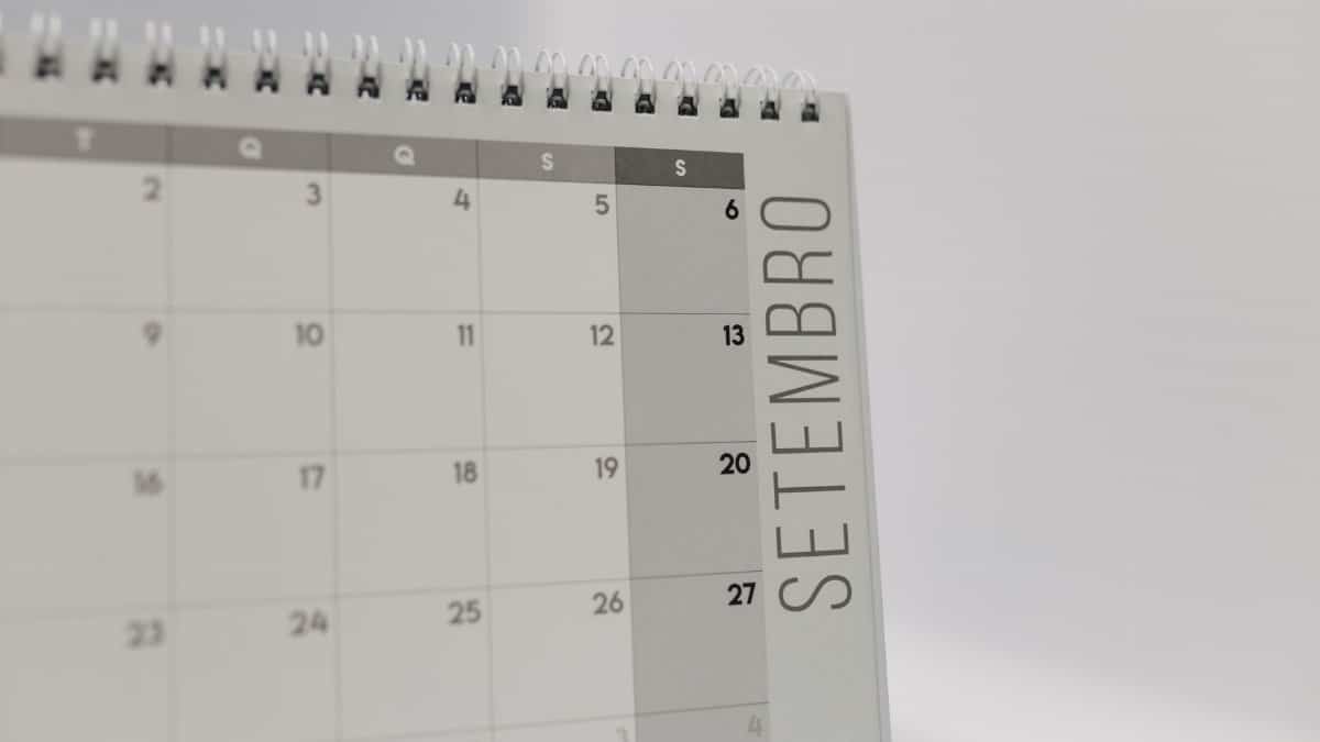 A desk calendar displaying the month of September with a spiral binding, in a minimalist design.