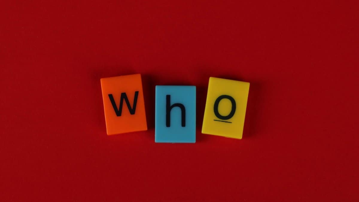 Alphabet blocks forming the word 'who' against a vibrant red backdrop.