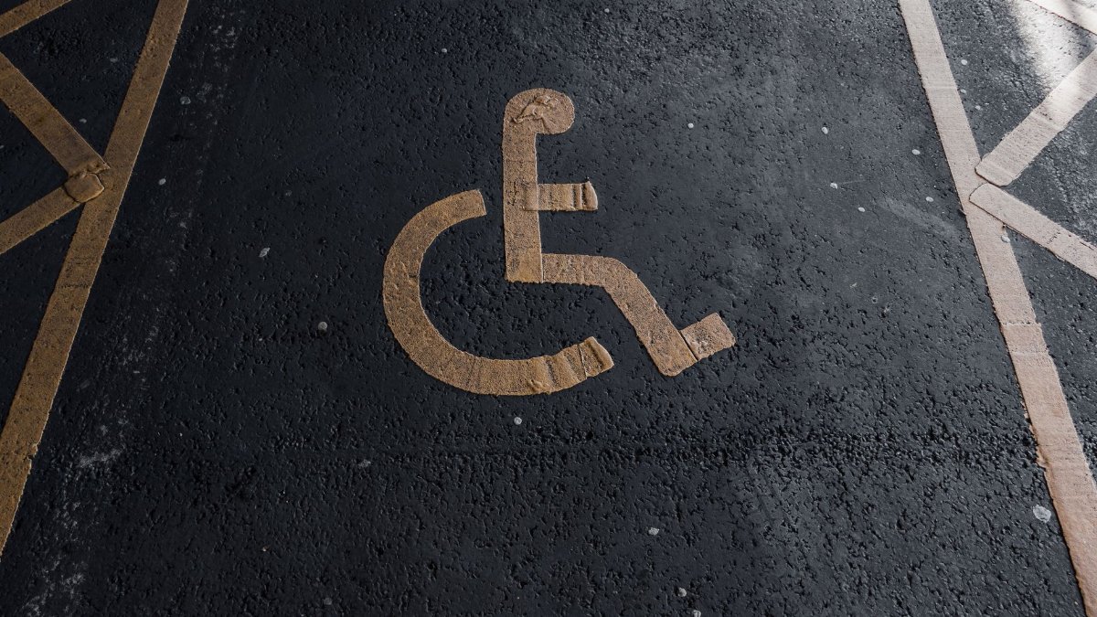 Close-up of a handicapped parking sign painted on pavement for accessibility clarity.